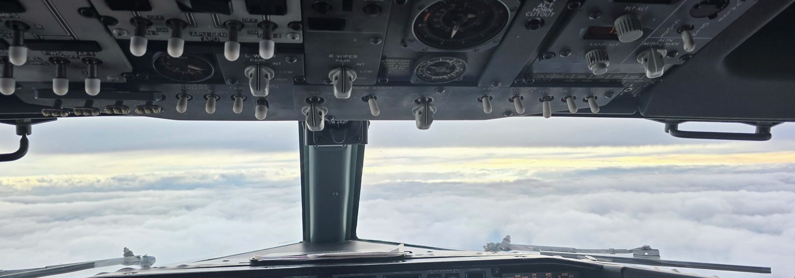View from a 737 flight deck above the clouds at cruise altitude